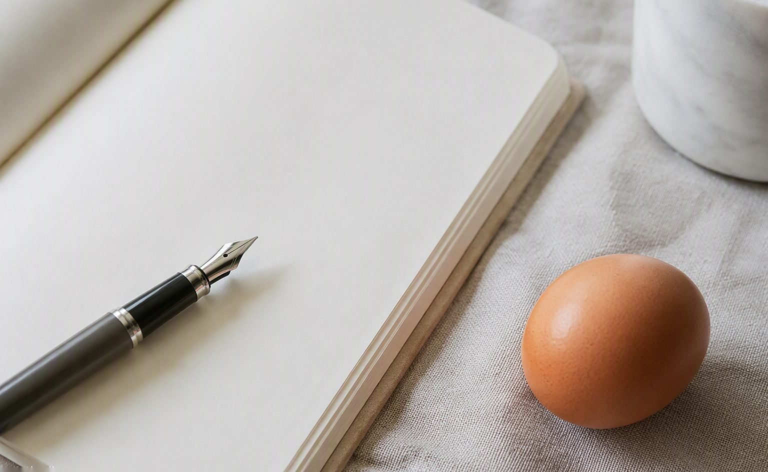 Illustrative image — Egg powder in a glass bowl beside fresh brown eggs on a pale worktop